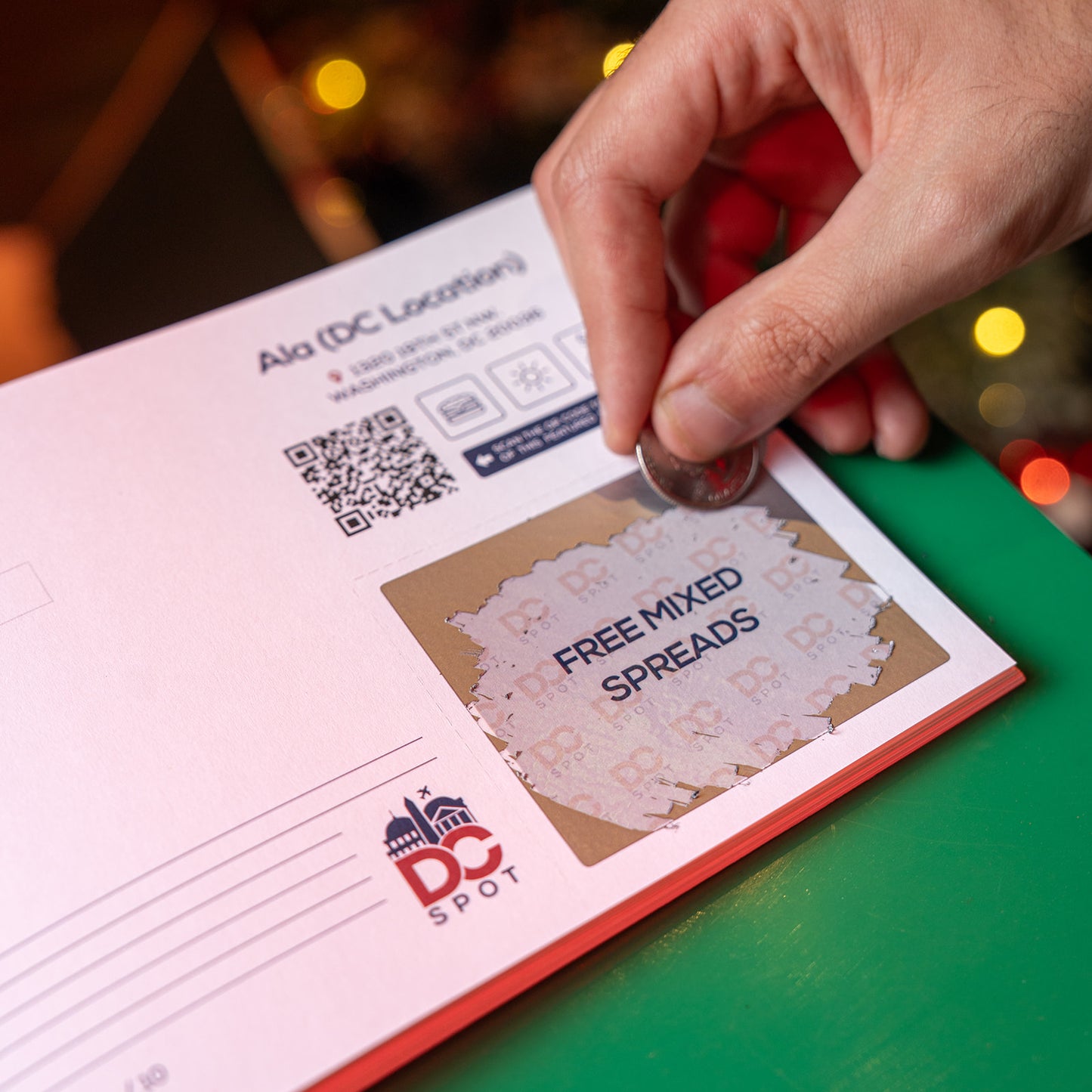 Person scratching off an exclusive deal in the Washington DC Discovery Book to reveal a unique offer and find things to do in DC