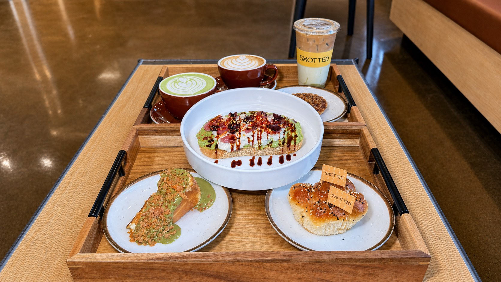 Shotted Coffee food spread with avocado toast, pastries, latte, matcha and an iced specialty drink