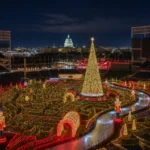 Aerial view of the Enchant Christmas light maze and ice skating trail at Nationals Park in Washington DC with the US Capitol dome lit in the background