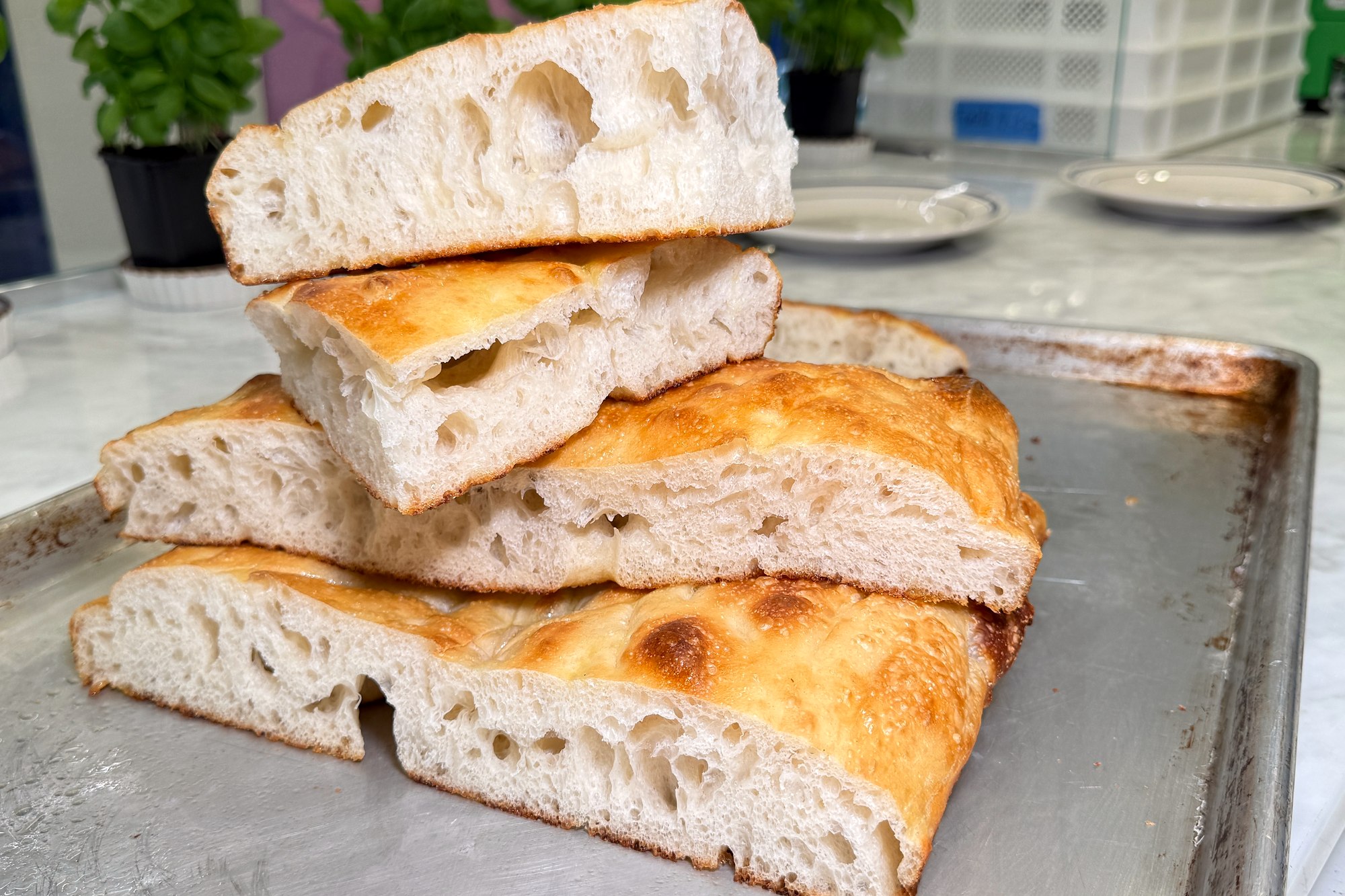 Stacked pieces of house-made focaccia at La Pâte