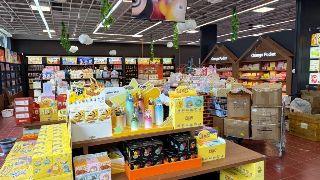 Blind box displays on tables in the middle of Orange Pocket, with shelves of collectibles behind