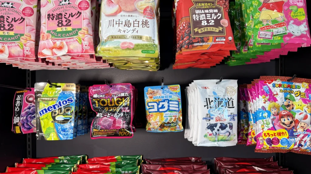 Shelves of Japanese snacks at Orange Pocket, including flavored Kit Kats and fruit gummies