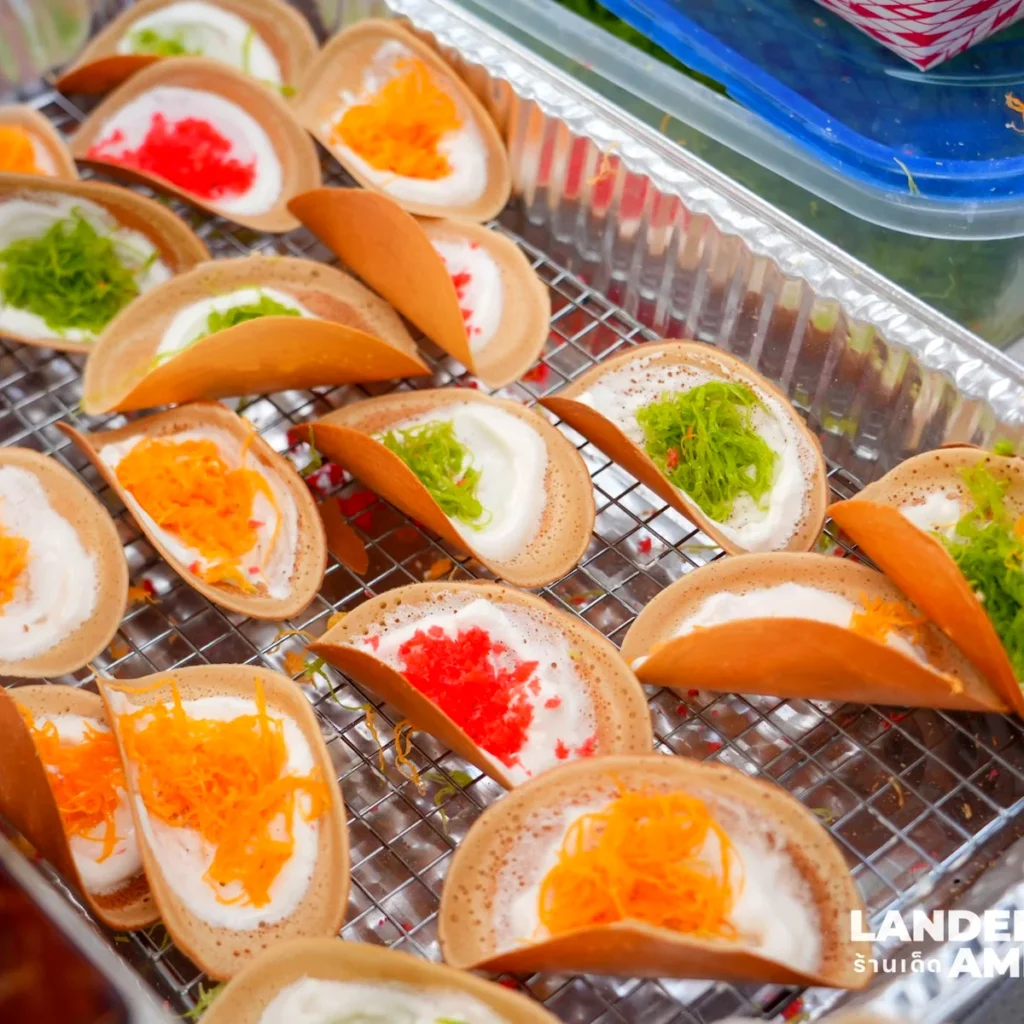 Trays of khanom bueang, crispy Thai crepes filled with cream and colored shredded topping, at Sawasdee DC