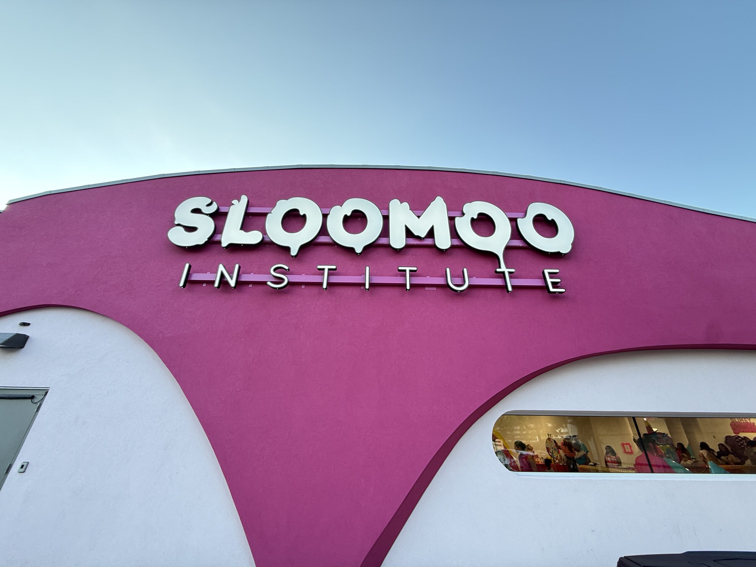 Sloomoo Institute lettering on the pink exterior at Tysons Corner Center