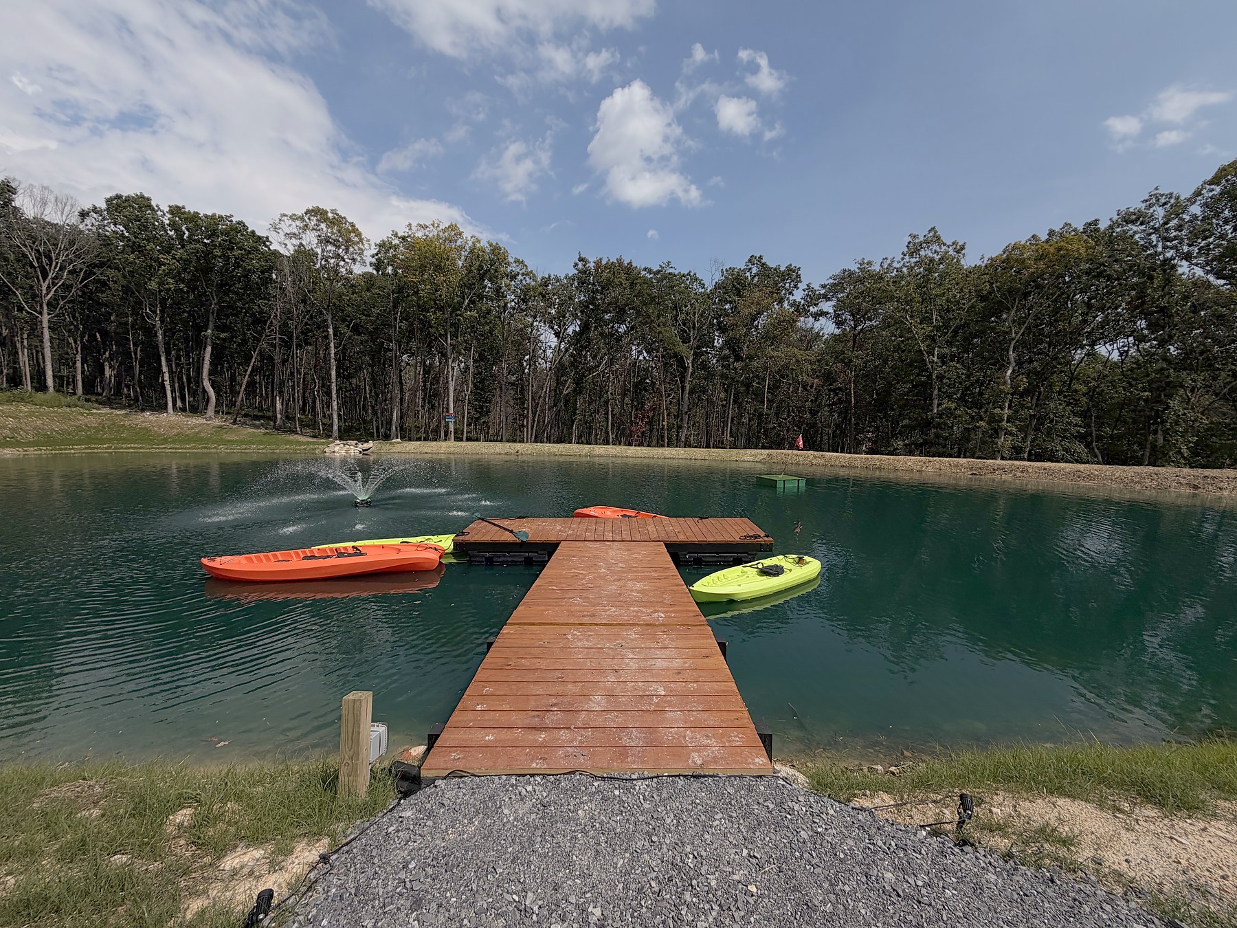 Kayaks beside the wooden dock on Luray Yurt’s private pond