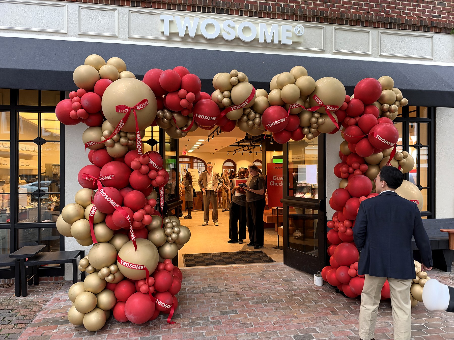 Twosome Place storefront with red and gold balloons at 404 King Street in Old Town Alexandria
