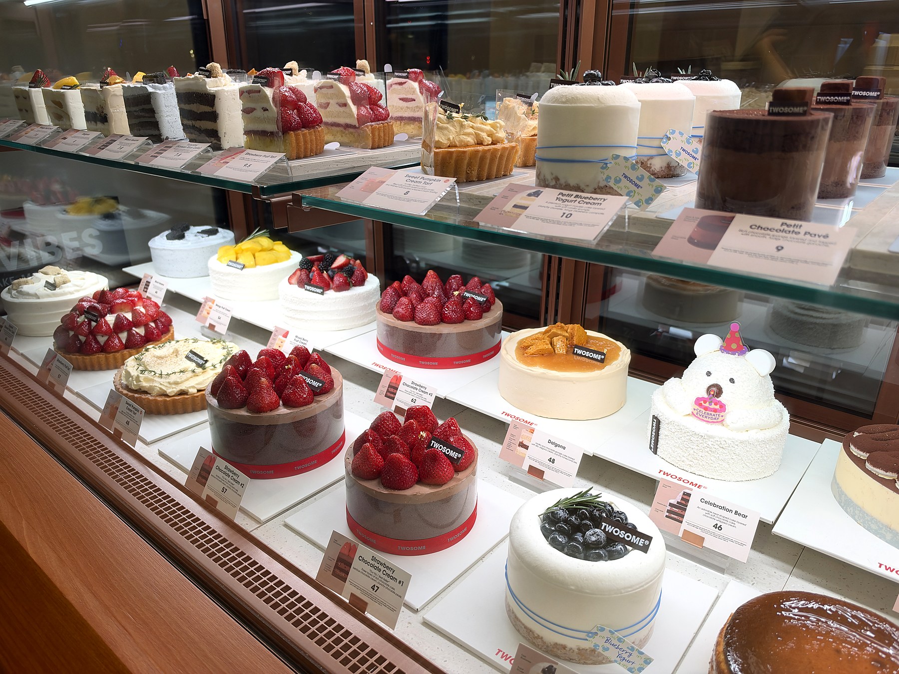 Whole strawberry chocolate cakes and individual desserts in the Twosome Place Alexandria display case