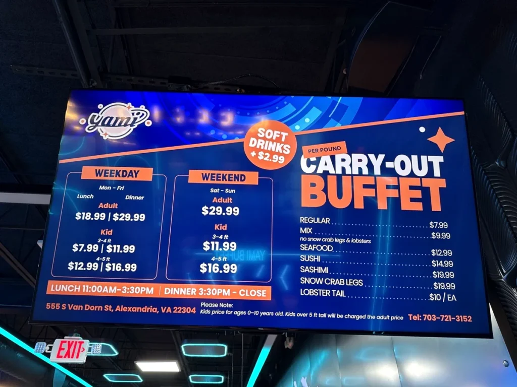 Yami Buffet price board: weekday lunch $18.99 and dinner $29.99 for adults, weekend $29.99, kids $7.99 to $16.99 by height, soft drinks $2.99, and carry-out buffet prices per pound